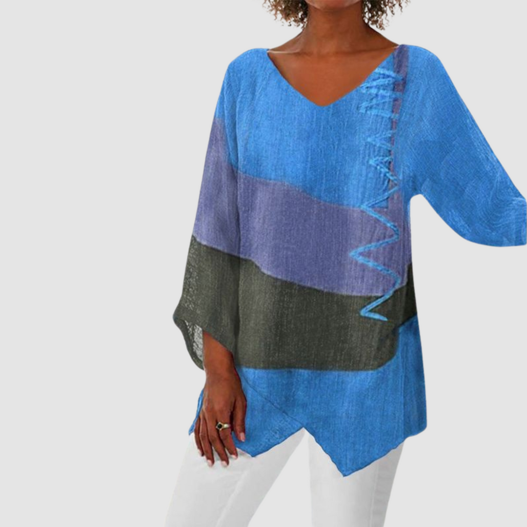Bold blue, purple, and black loose breathable shirt with asymmetrical hem in studio setting.