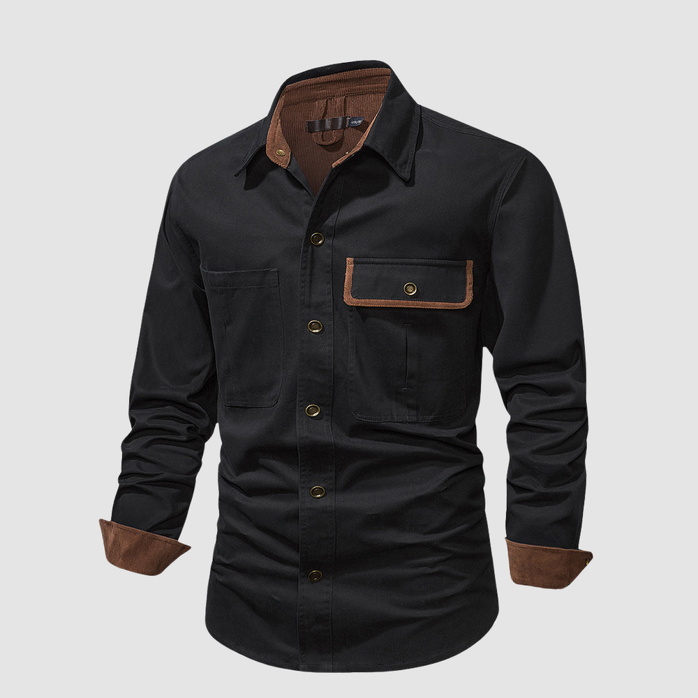 Black long-sleeved shirt angled view, brown accents, front pocket detail, studio background.