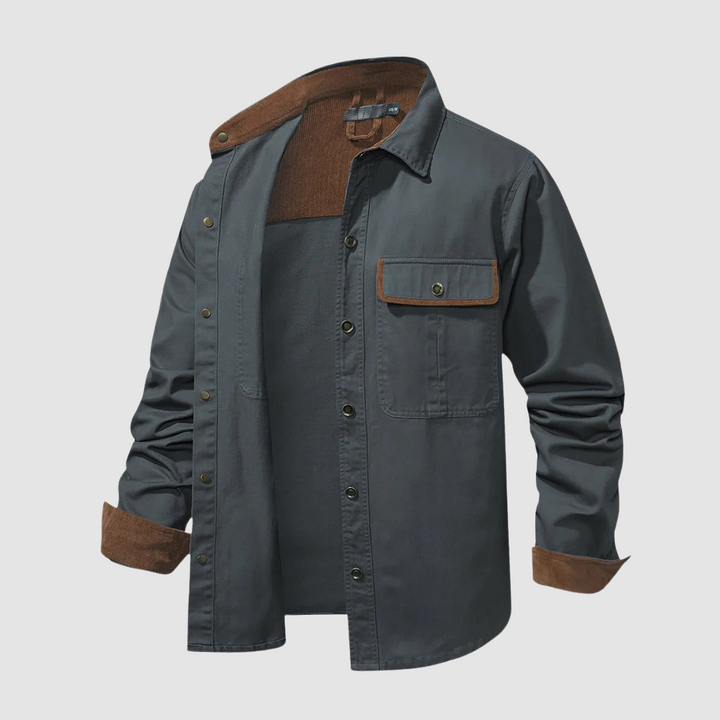 Grey shirt partially open, brown inner collar, front pocket detail, studio setting.