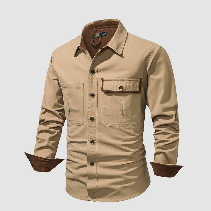 Tan shirt angled view, brown inner accents, front pocket detail, studio backdrop.