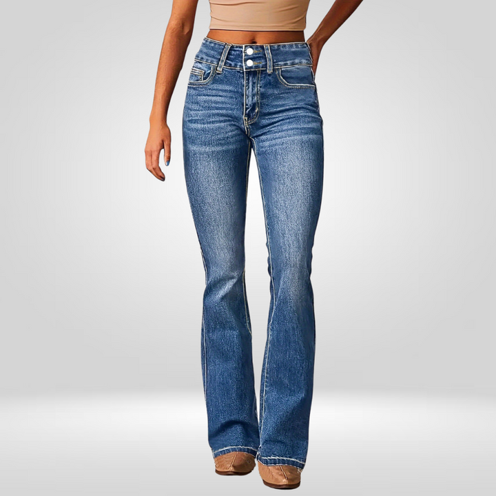 Front view of high-flared blue jeans worn by a model in a studio.