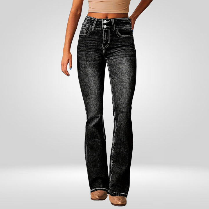 Front view of high-flared black jeans worn by a model in a studio.