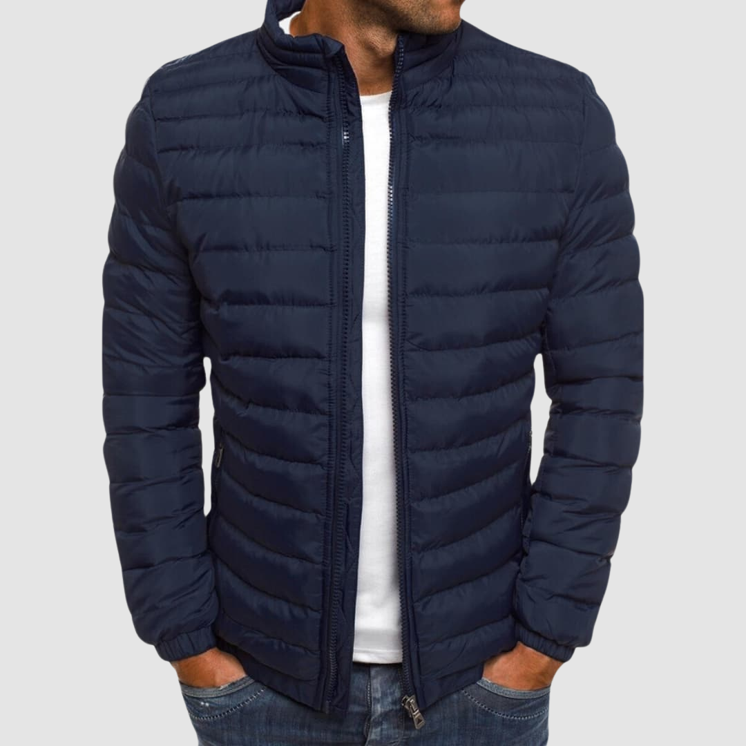 Navy lightweight summer jacket with a front zipper, modeled with hands in pockets against a plain background.