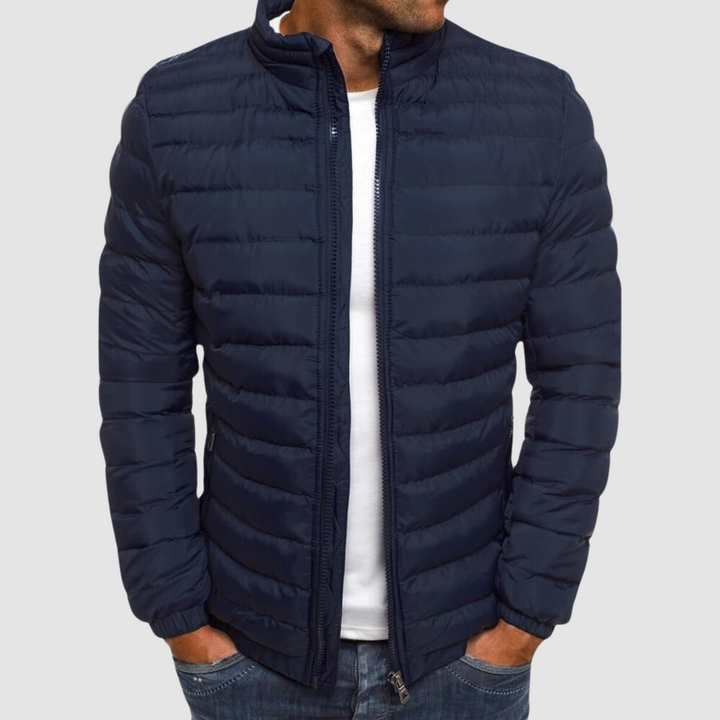 Navy lightweight summer jacket with a front zipper, modeled with hands in pockets against a plain background.