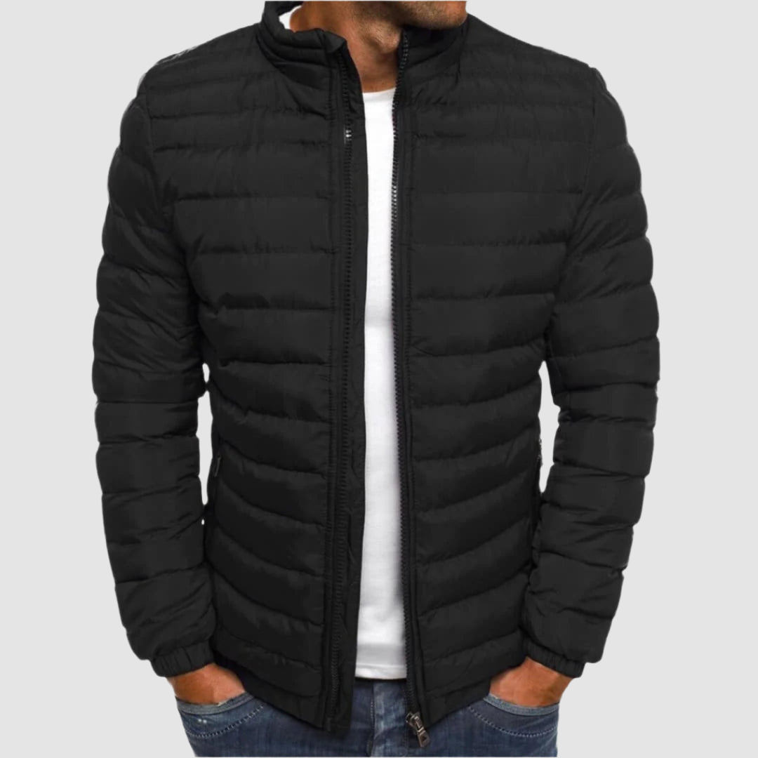 Black lightweight summer jacket with a front zipper, modeled with hands in pockets against a plain background.