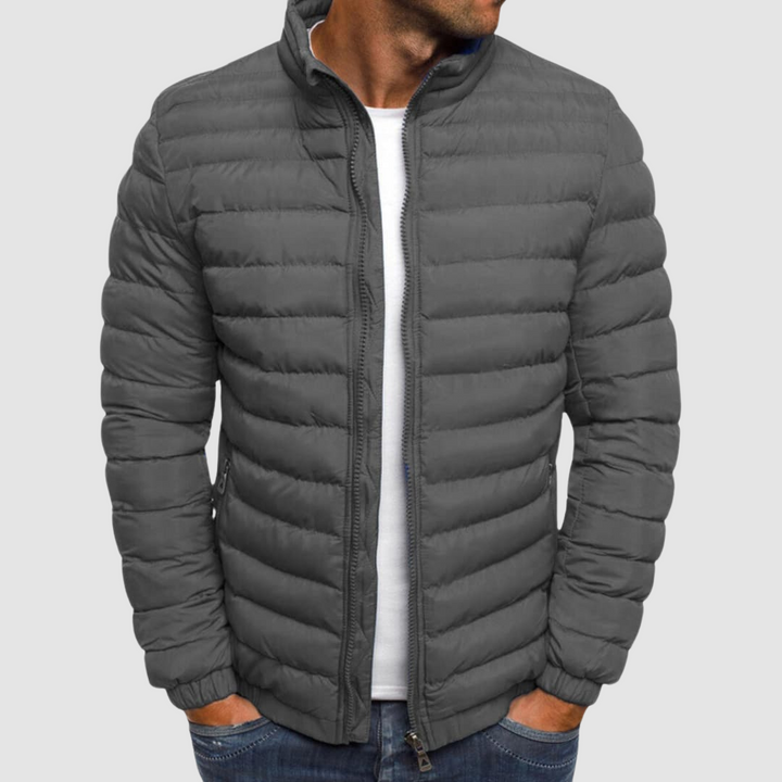 Gray lightweight summer jacket with a front zipper, modeled with hands in pockets against a plain background.