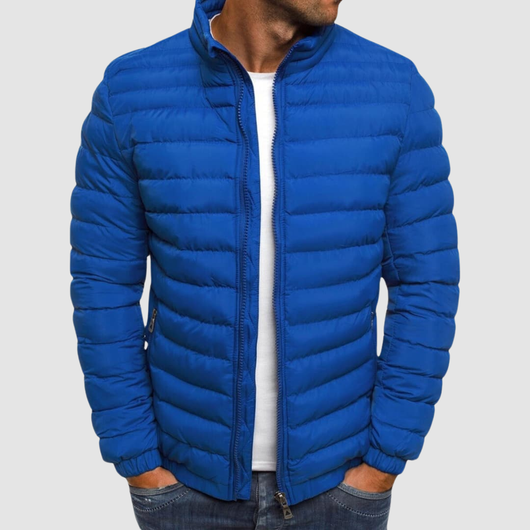 Blue lightweight summer jacket with a front zipper, modeled with hands in pockets against a plain background.