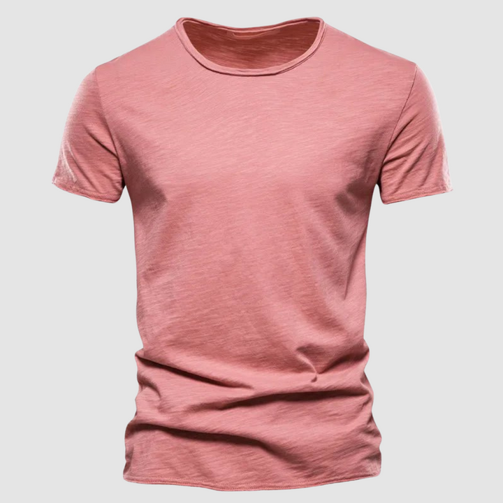 Pink short-sleeve t-shirt with a round neck on a plain background.