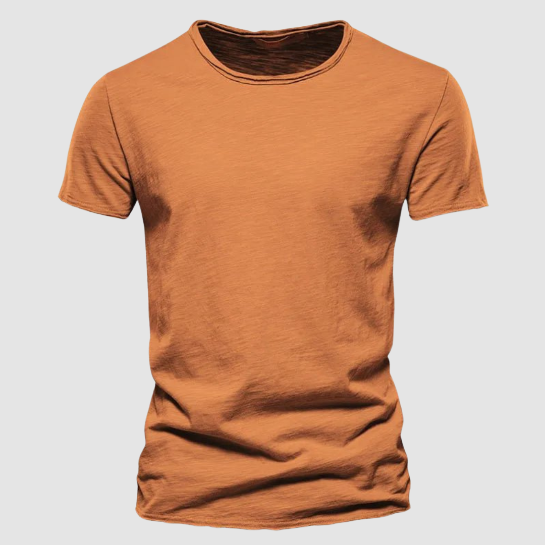 Orange short-sleeve t-shirt with a round neck on a plain background.