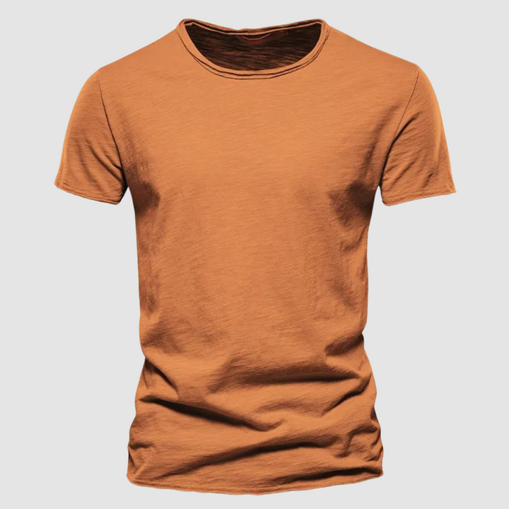 Orange short-sleeve t-shirt with a round neck on a plain background.