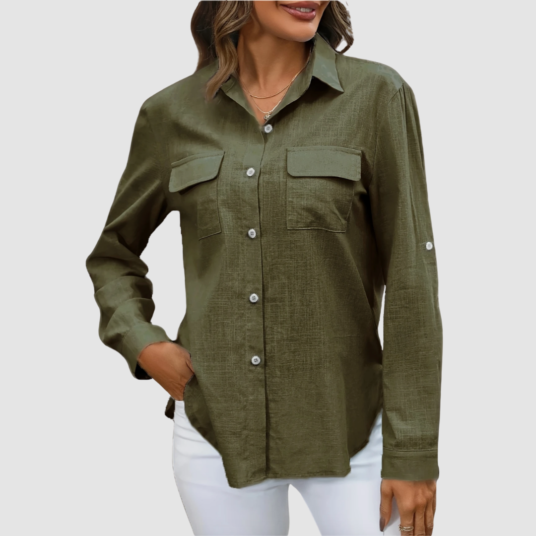 Olive pocket blouse with long sleeves and front pockets, hand in pocket, studio background.