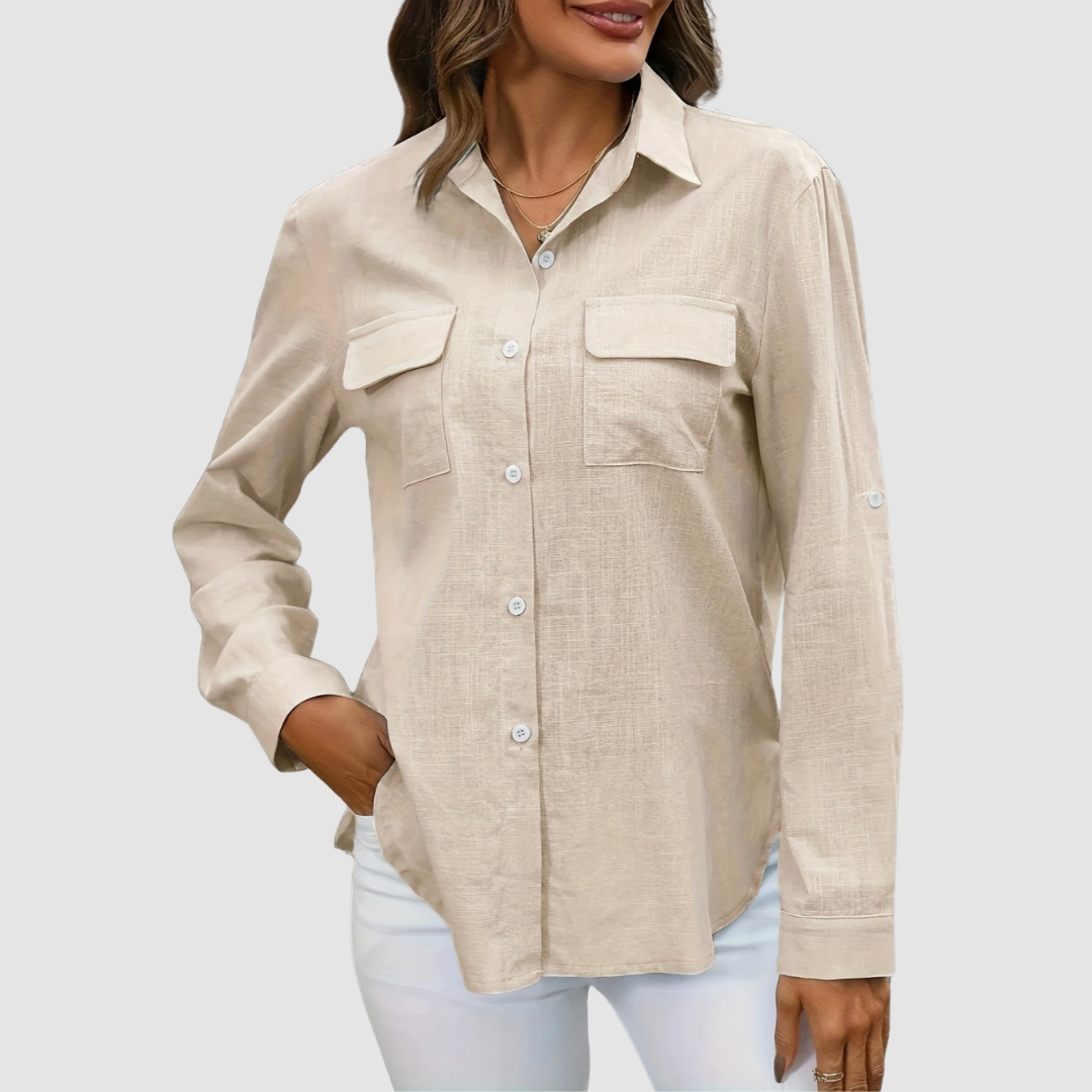 Beige pocket blouse with long sleeves and front pockets, hand in pocket, studio background.