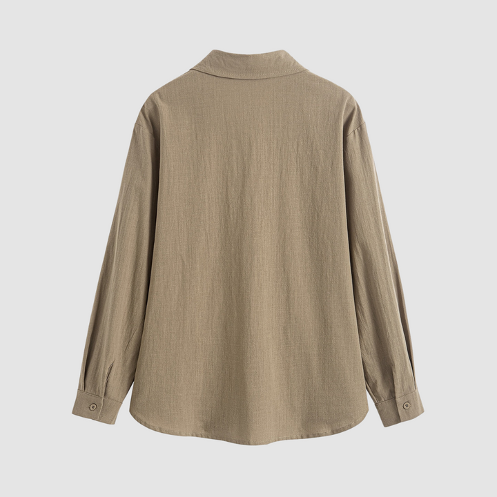 Back view of a soft, classic pocket blouse in beige, shown on a white backdrop.