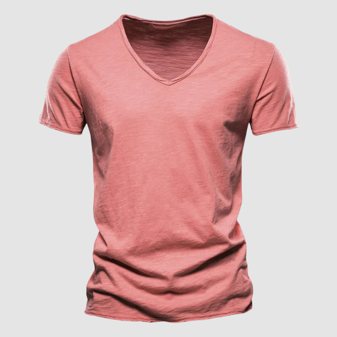 Coral pink V-neck summer tee with short sleeves in a studio setting.