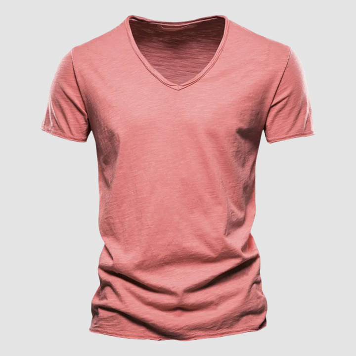 Coral pink V-neck summer tee with short sleeves in a studio setting.