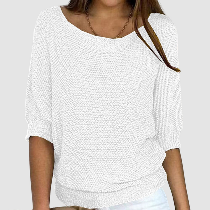 White knitted sweater with a boat neckline and three-quarter sleeves, worn by a model against a plain background.