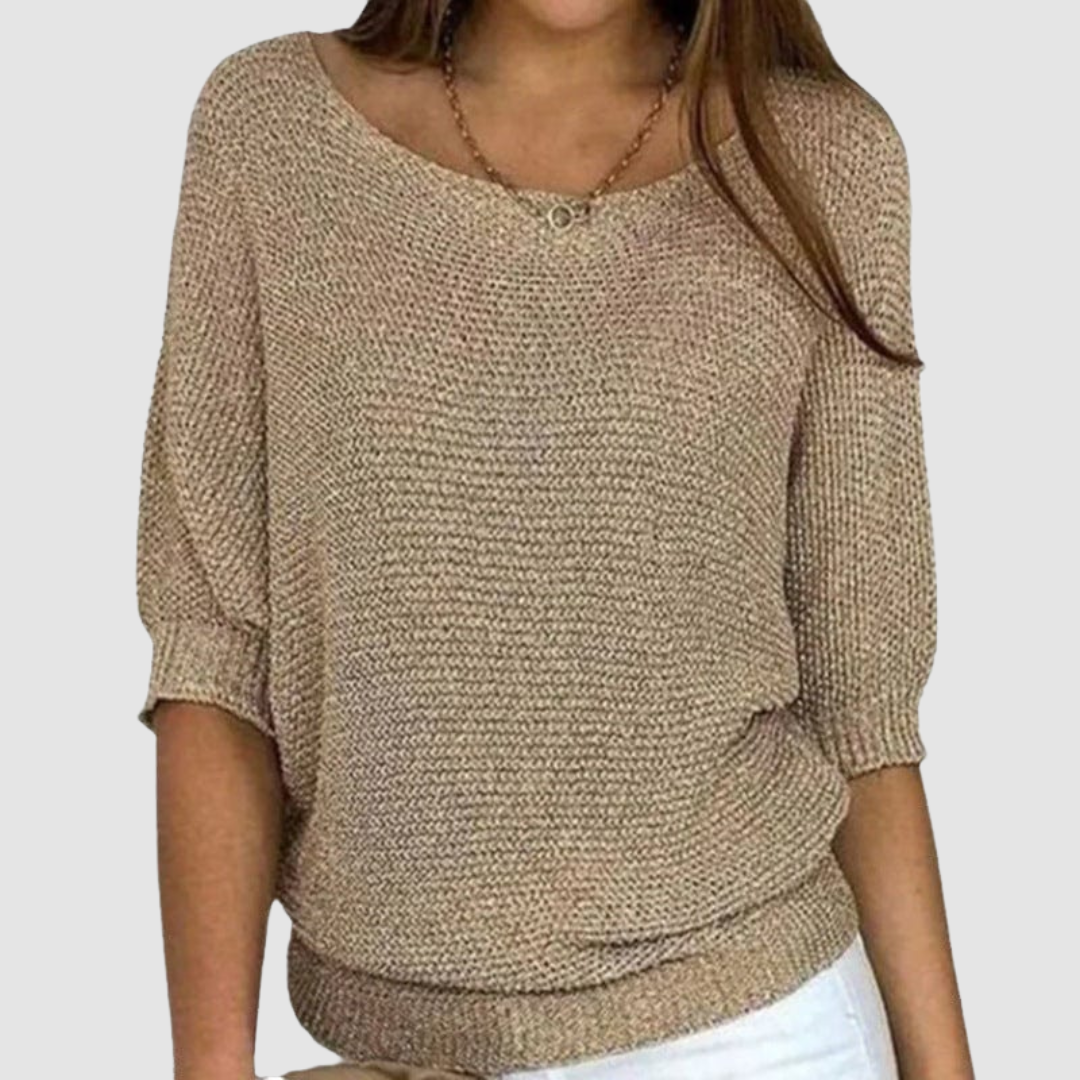 Beige knitted sweater with a boat neckline and three-quarter sleeves, worn by a model against a plain background.