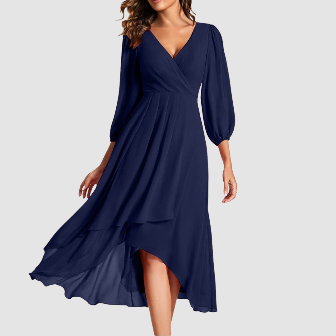 Elegant V-neck long dress in navy blue, featuring flowing layers and three-quarter sleeves, studio setting.