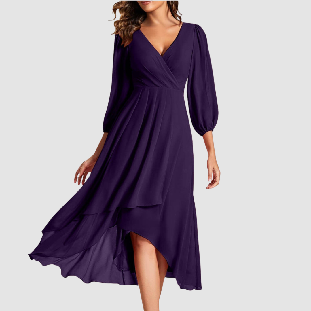 Elegant V-neck long dress in deep purple, featuring flowing layers and three-quarter sleeves, studio setting.