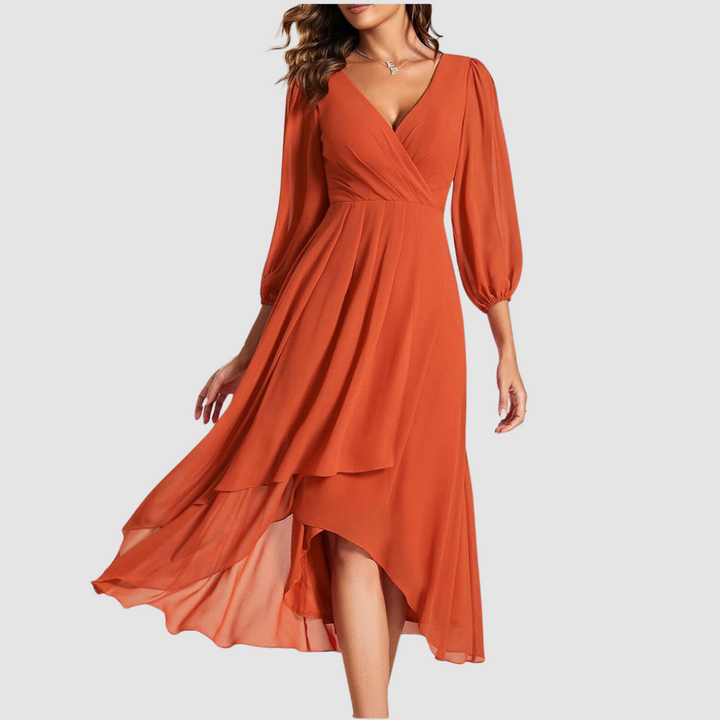 Elegant V-neck long dress in vibrant orange, with flowing layers and three-quarter sleeves, studio setting.