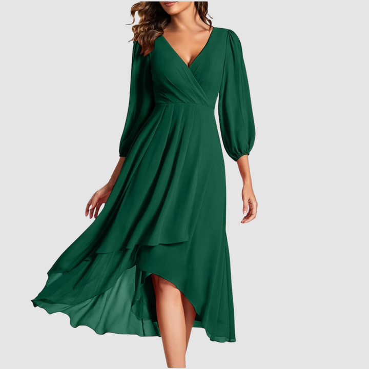 Elegant V-neck long dress in deep green, showcasing flowing layers and three-quarter sleeves, studio setting.