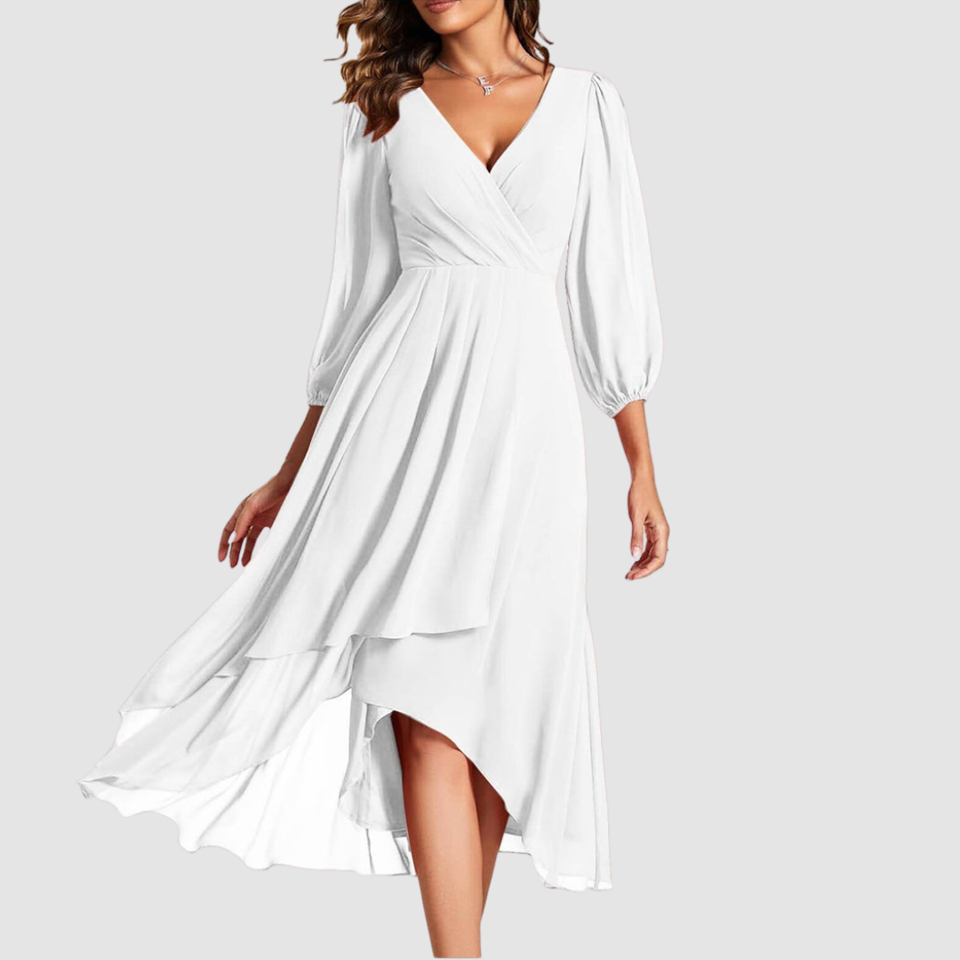 Elegant V-neck long dress in pure white, with flowing layers and three-quarter sleeves, studio setting.