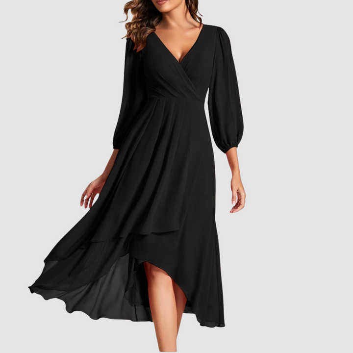 Elegant V-neck long dress in classic black, showcasing flowing layers and three-quarter sleeves, studio setting.