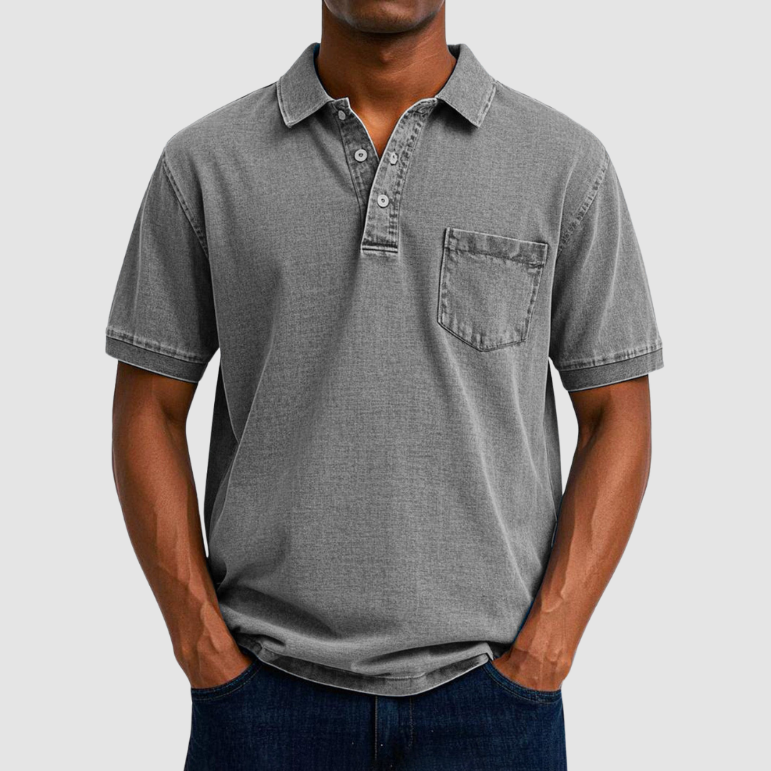 Gray casual polo shirt with short sleeves and buttoned collar, worn by a model, photographed in a studio.