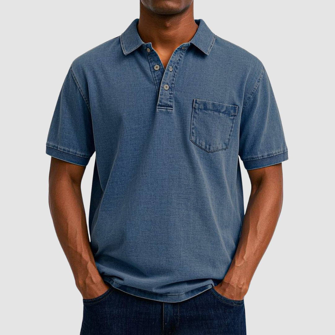 Slate blue casual polo shirt with short sleeves and buttoned collar, worn by a model in a studio setting.