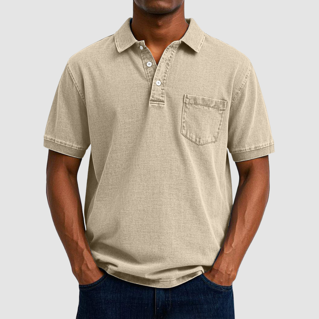 Beige casual polo shirt with short sleeves and buttoned collar, worn by a model, studio background.