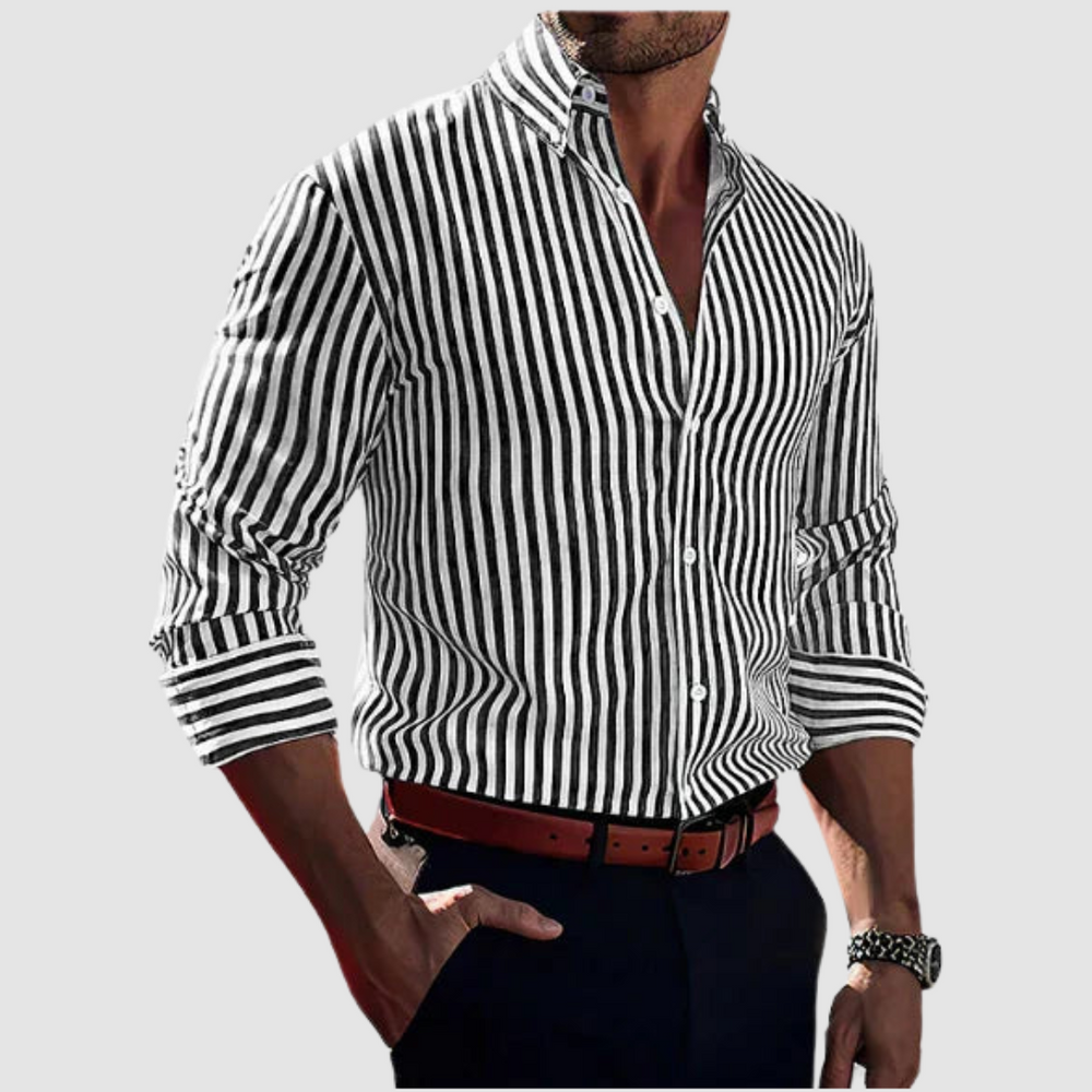 Men's black and white striped shirt, long sleeves rolled up, worn with a brown belt, set against a gray background.