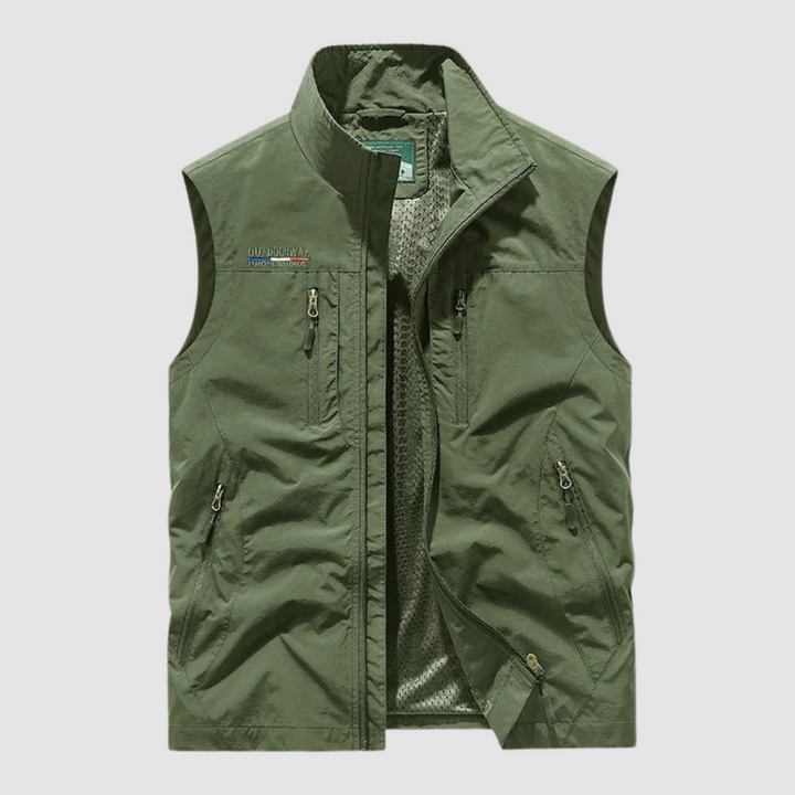 Olive green breathable utility vest with zipper pockets on a light gray background.