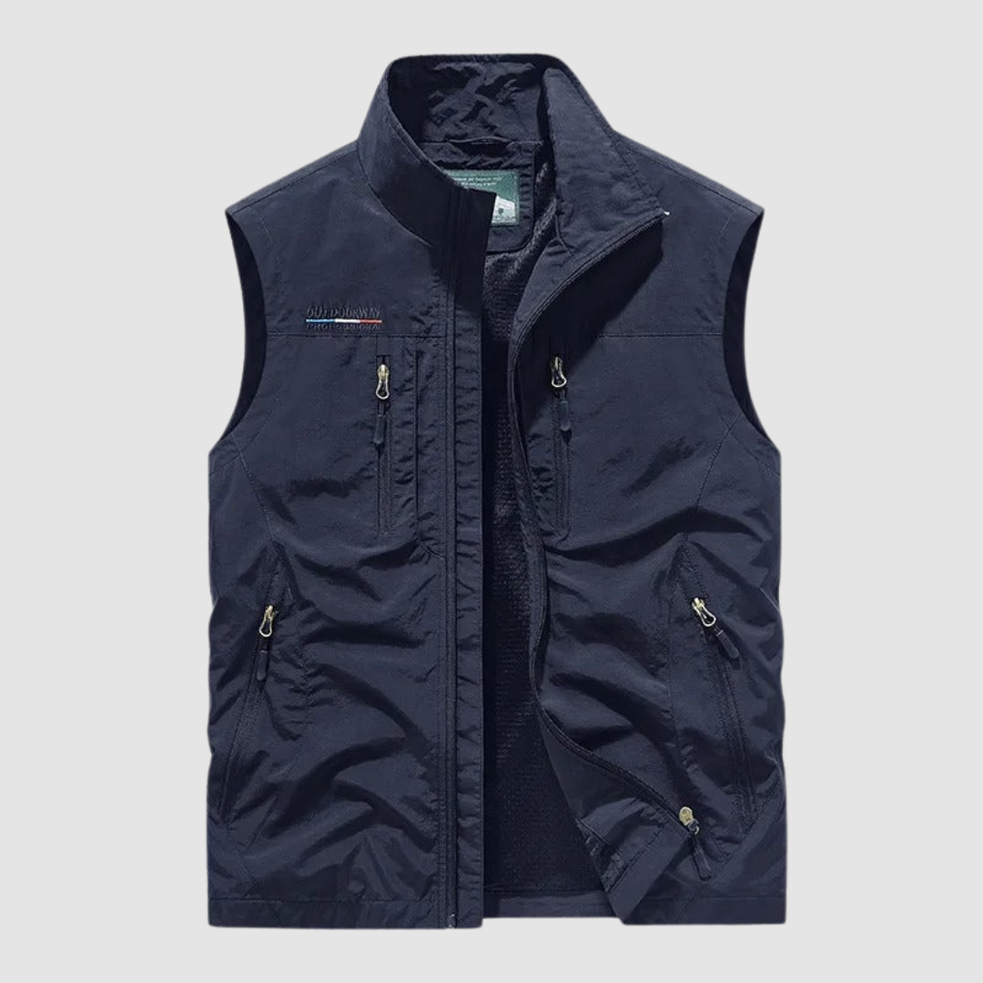 Dark blue breathable utility vest with zipper pockets on a light gray background.