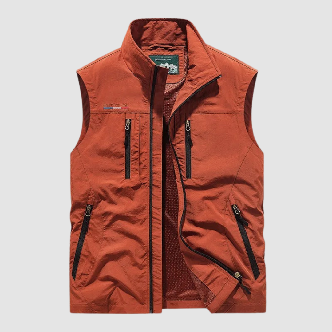 Orange breathable utility vest with zipper pockets on a light gray background.