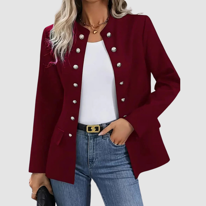 Burgundy blazer with silver buttons, worn over white top and jeans, accessorized with black belt, studio backdrop.