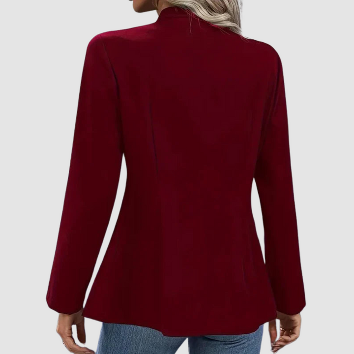 Back view of burgundy blazer, showing tailored fit, styled with jeans in studio setting.