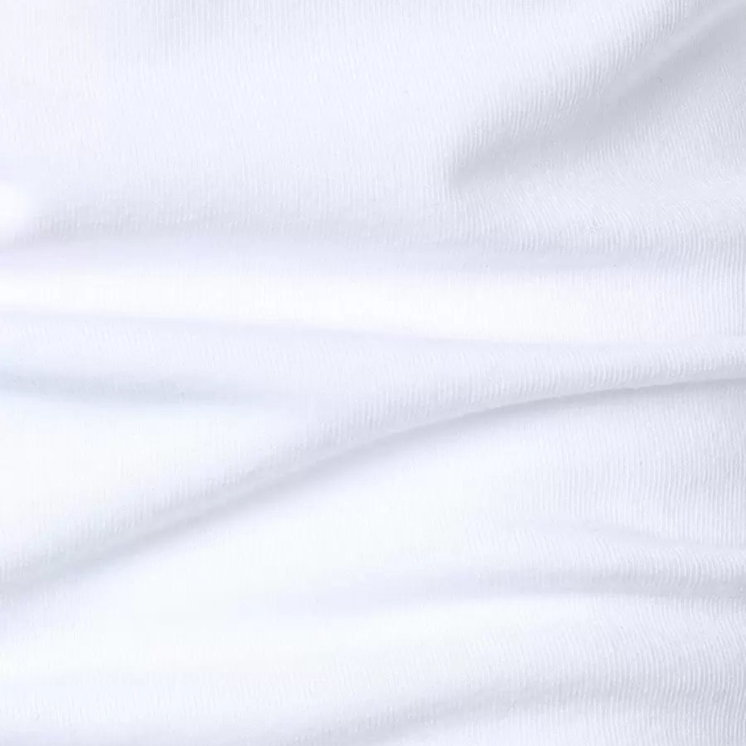 Close-up of soft, textured white fabric showing fine details of the polo shirt.