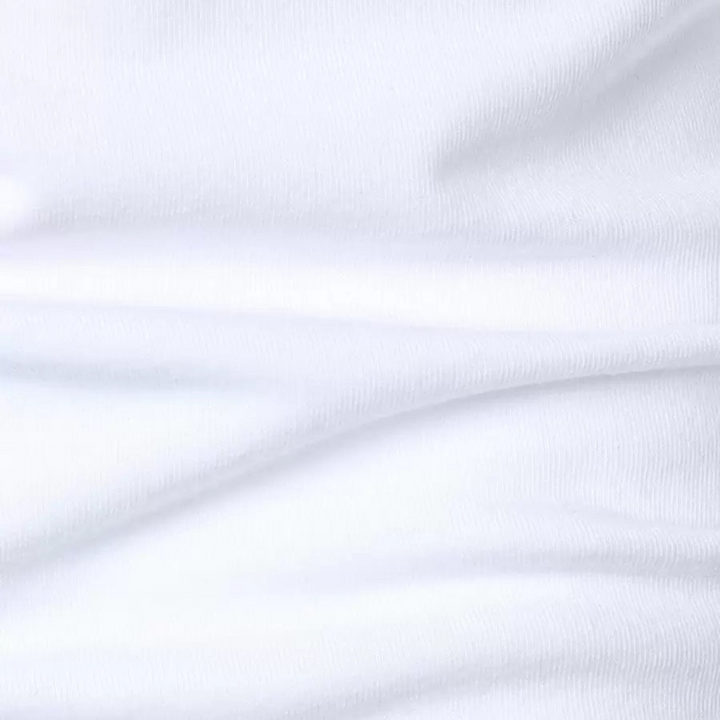 Close-up of soft, textured white fabric showing fine details of the polo shirt.