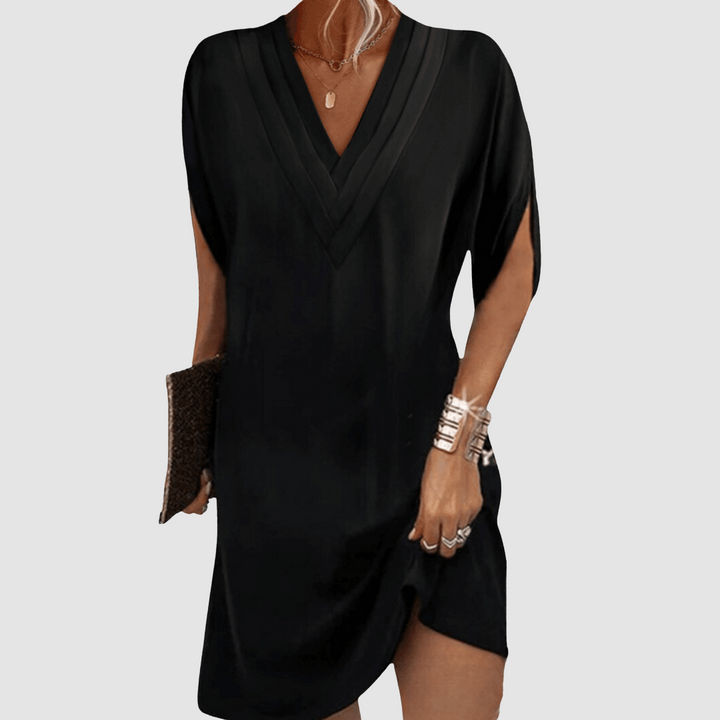 Stylish black half-sleeve dress with chic V-neck, set on a light grey backdrop.