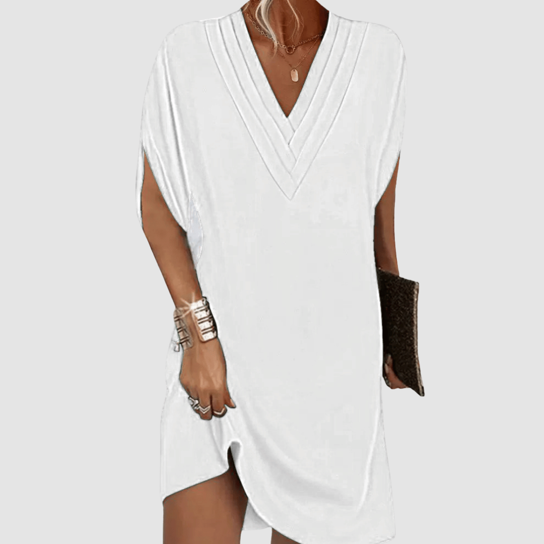 Elegant white half-sleeve dress with a classic V-neck, shown on a light grey background.