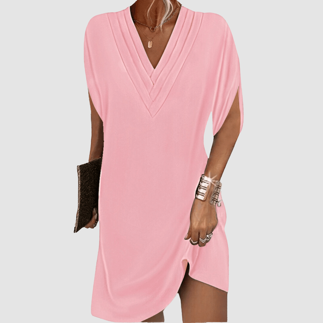 Soft pink half-sleeve dress featuring a V-neck, displayed on a light grey background.