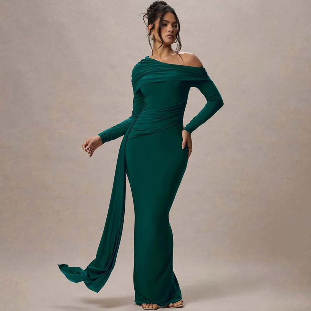 Sophisticated model in dark green off-shoulder maxi dress with draped feature in studio background.