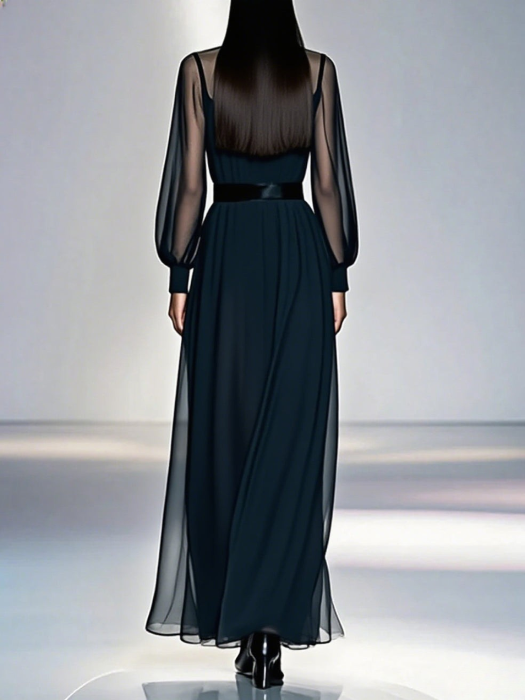 Back view of elegant black dress with sheer sleeves and sleek fit, in a studio setting.