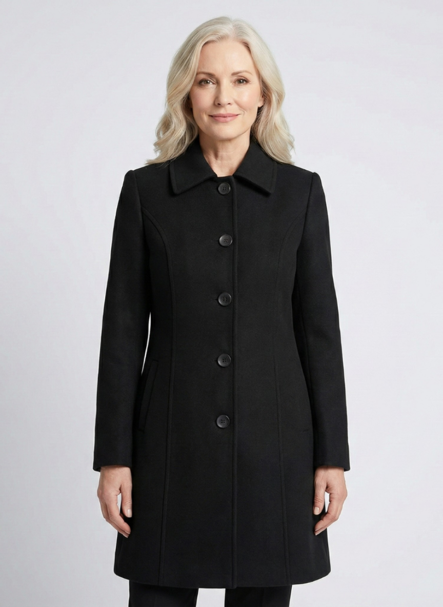 Front view of black elegant coat worn by a person in a light studio setting.