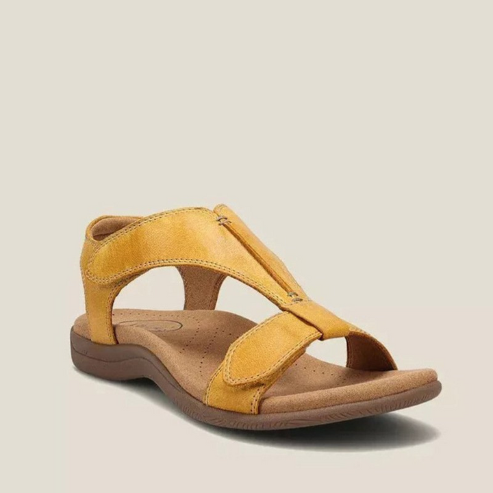 Yellow orthopedic sandal featuring comfort footbed, adjustable straps, and casual style on beige background.