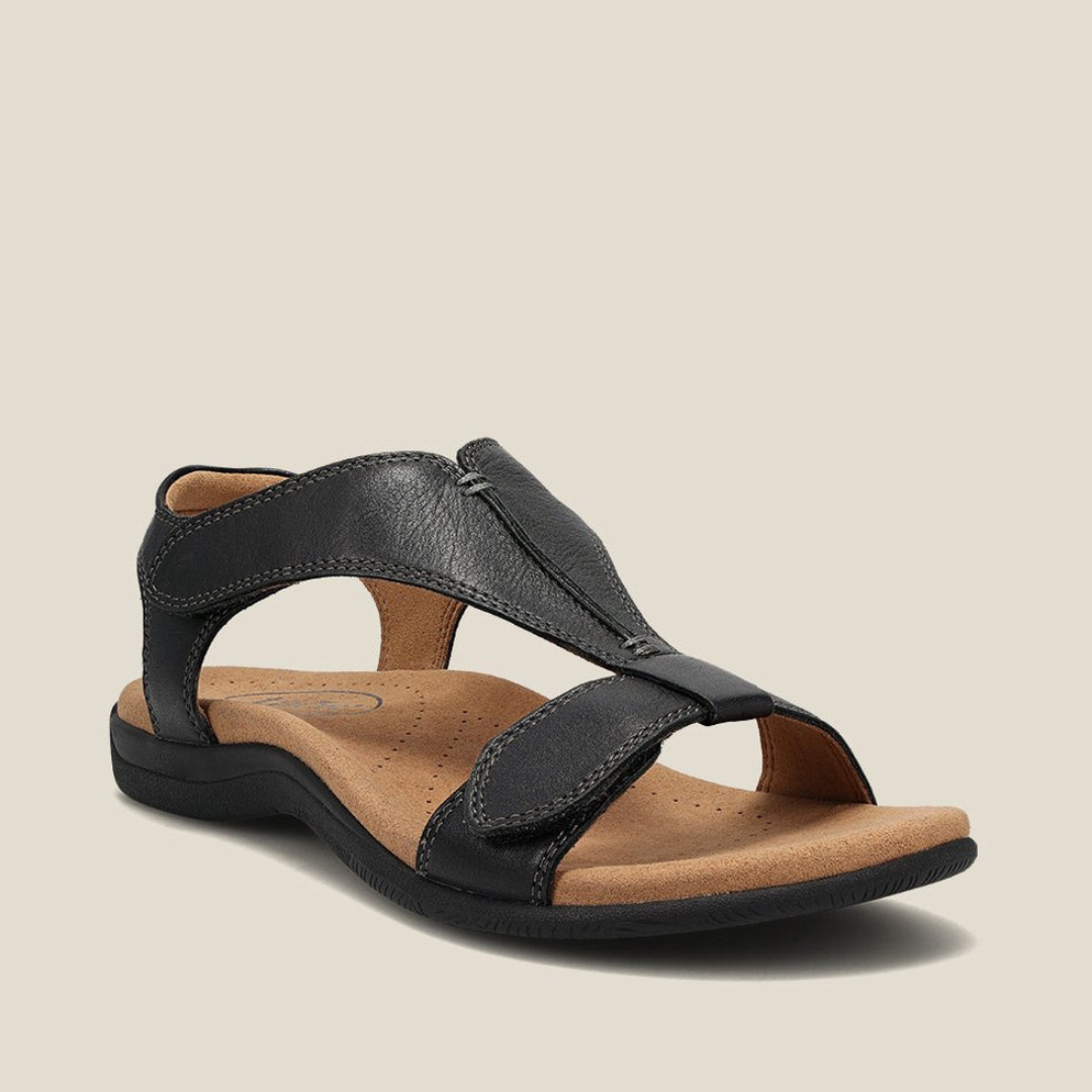 Black orthopedic sandal featuring a comfortable footbed, sturdy straps, and elegant design on neutral backdrop.