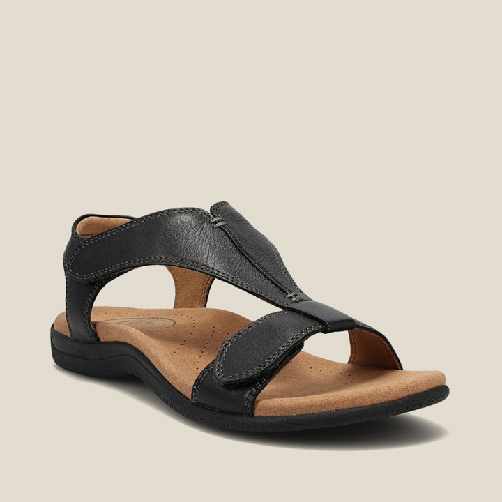 Black orthopedic sandal featuring a comfortable footbed, sturdy straps, and elegant design on neutral backdrop.