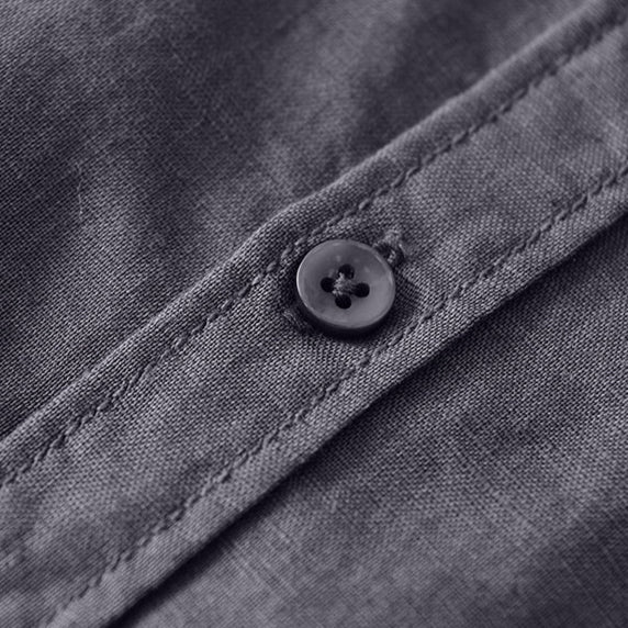 Close-up of dark linen shirt button and stitching.