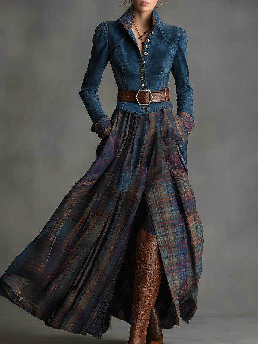 Elegant outfit with a blue suede fitted jacket with button details, paired with a flowing plaid skirt and brown boots in a studio setting.