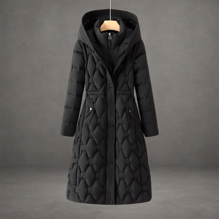 Elegant black coat with textured quilted pattern and hood in a studio setting.
